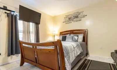 a bedroom with a bed and a sign on the wall at Private 1 Bed 1 Bath Orlando Oasis Shopping and Parks Nearby in Orlando