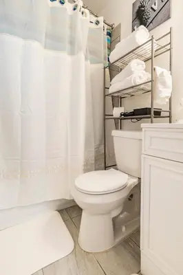 a white bathroom with a toilet and a shower at Private 1 Bed 1 Bath Orlando Oasis Shopping and Parks Nearby in Orlando