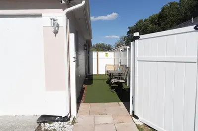 a white fence with a gate and a patio at Private 1 Bed 1 Bath Orlando Oasis Shopping and Parks Nearby in Orlando