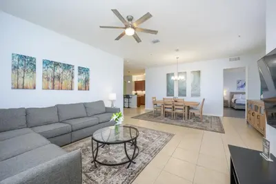 a living room with a couch and a table at Beautiful Lakeview Vacation Condo, Vista Cay 1016 in Orlando