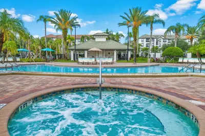 a pool at a resort with palm trees at Beautiful Lakeview Vacation Condo, Vista Cay 1016 in Orlando
