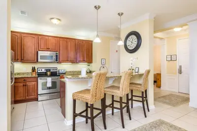 a kitchen with a large island with bar stools at Gorgeous 3 Bed Lakeview, Vista Cay - 1010 in Orlando
