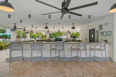 a bar with stools in the middle of a room at Epic Universe Vista Cay Lakeview Condo - 1019 in Orlando