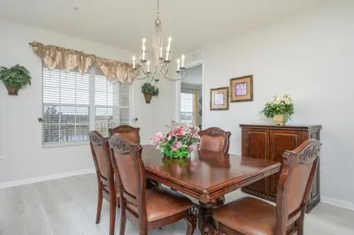 a dining room with a wooden table and chairs at Epic Universe Vista Cay Lakeview Condo - 1019 in Orlando