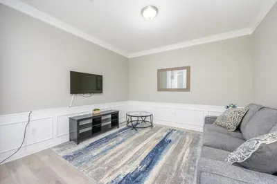 a living room with a couch and a flat screen tv at Beautiful Epic Universe Condo, Vista Cay - 1004 in Orlando