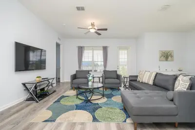 a living room with a couch and a tv at Stunning Epic Universe Condo - Vista Cay Resort - 2016 in Orlando