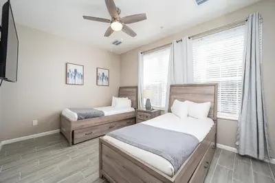 a bedroom with two beds and a ceiling fan at Beautiful Family Townhome, Near The Parks - 4032 in Orlando