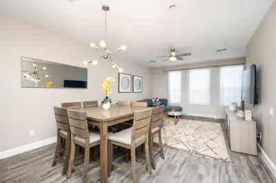 a dining room and living room with a table and chairs at Beautiful Family Townhome, Near The Parks - 4032 in Orlando