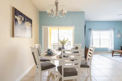 a dining room with a table and chairs at Cozy Retreat-Heated Pool, Grill, Pickle Ball, Gym in Kissimmee