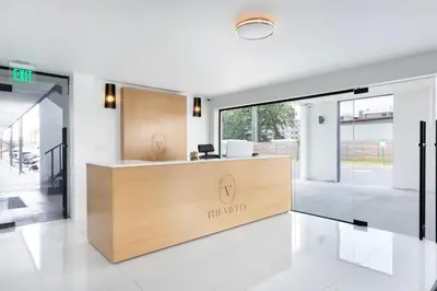 an office with a reception desk in a building at The Vietta Hotel in Kissimmee
