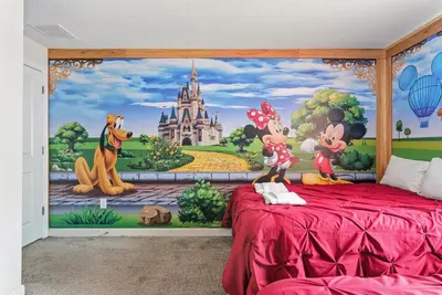 a bedroom with a disney mural on the wall at Relax Near Disney 4BR Home with Pool in Kissimmee