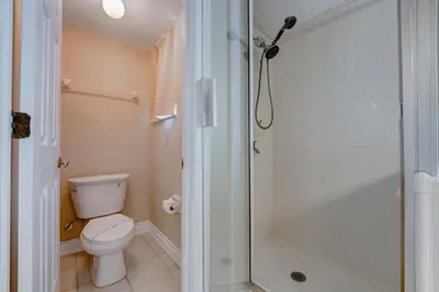 a bathroom with a toilet and a shower at Bay Pointe Pool Home Near Parks in Kissimmee