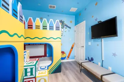 a childs room with a play bed and a tv at 4BR Themed Home W Resort Pool Near Disney in Kissimmee