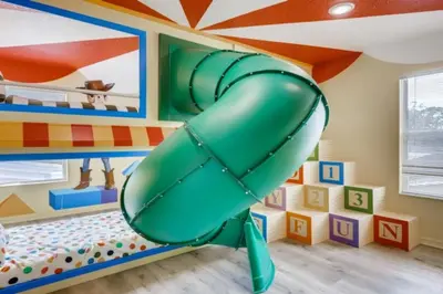 a slide in a childs room with a play area at Lakefront 6BR Resort Pool Home Near Disney World in Kissimmee