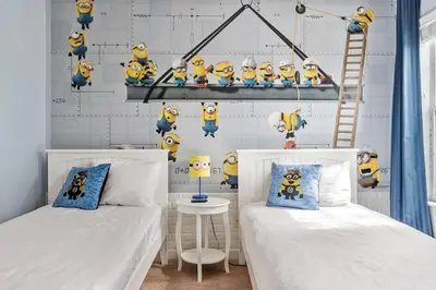 a bedroom with two beds and a wall filled with toys at Lakefront 5BR Family Resort Pool Home Near Disney in Kissimmee
