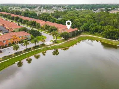 an aerial view of a house next to a lake at Lakefront 5BR Family Resort Pool Home Near Disney in Kissimmee