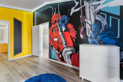 a room with a mural oftransformators at Fantastic 5BR Themed Pool Home Near Disney World in Kissimmee