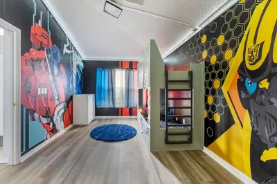 a room with a superhero mural on the wall at Fantastic 5BR Themed Pool Home Near Disney World in Kissimmee