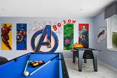 a room with a pool table and some paintings at Vila incrível 9 quartos | Perto da Disney in Kissimmee