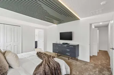 a bedroom with a bed and a tv on a wall at Stylish Family Retreat with Themed Bedrooms in Kissimmee