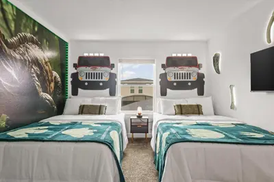 a room with two beds with a jeep on the wall at Stylish Family Retreat with Themed Bedrooms in Kissimmee