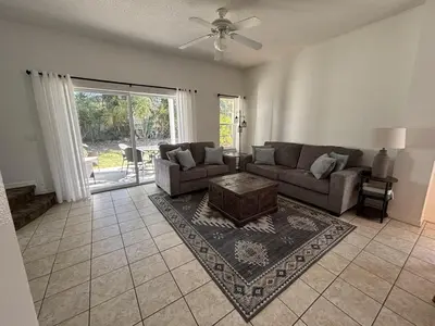 a living room with a couch and a table at Relax and unwind in this Cozy Home Away from Home in Kissimmee
