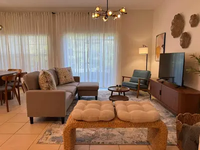 a living room with a couch and a tv at 2335 Amazing 5BD Family Townhome Close to Disney in Kissimmee