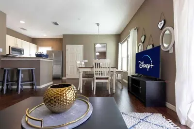 a kitchen and living room with a vase on a table at 4BR Family Townhouse Steps to Disney in Kissimmee