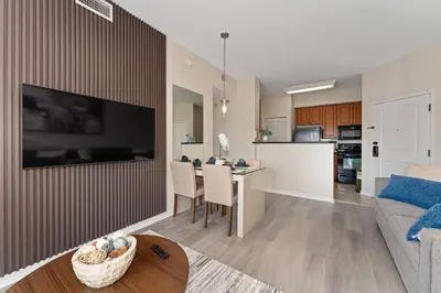 a living room with a couch and a table with chairs at Cozy Apartment w Kitchen Near Universal in Orlando