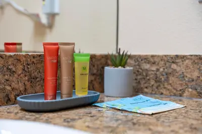 a tray with four different colored hair products on a counter at Cozy Apartment w Kitchen Near Universal in Orlando