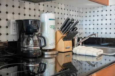 a kitchen counter with a coffee maker on a counter top at Cozy Apartment w Kitchen Near Universal in Orlando