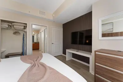 a bedroom with a bed and a flat screen tv at Cozy Apartment w Kitchen Near Universal in Orlando