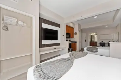 a bedroom with two beds and a flat screen tv at King Queen Spacious Studio Near Universal in Orlando