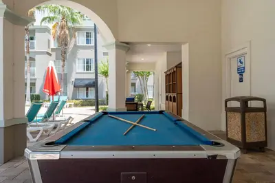 a pool table in the middle of a room at King Queen Spacious Studio Near Universal in Orlando