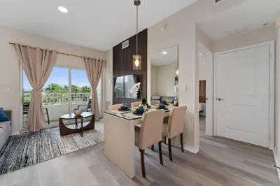 a kitchen and dining room with a table and a living room at Combined units 2 Kitchens Sleeps 6 in Orlando
