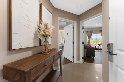 a living room with a vase of flowers on a wooden table at Combined units 2 Kitchens Sleeps 6 in Orlando