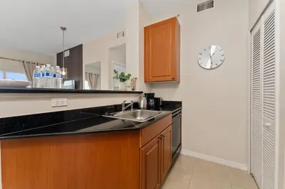a kitchen with a sink and a clock on the wall at Combined units 2 Kitchens Sleeps 6 in Orlando