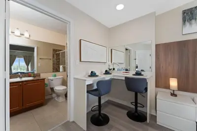 a bathroom with a vanity and a toilet and a sink at Combined units 2 Kitchens Sleeps 6 in Orlando