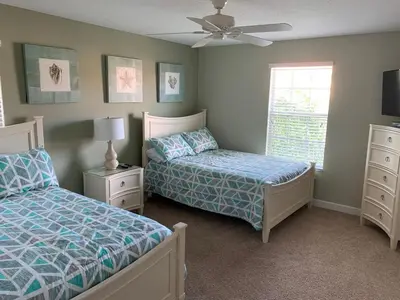 a bedroom with two beds and a ceiling fan at Relaxing Villa very close to Disney and Universal in Kissimmee