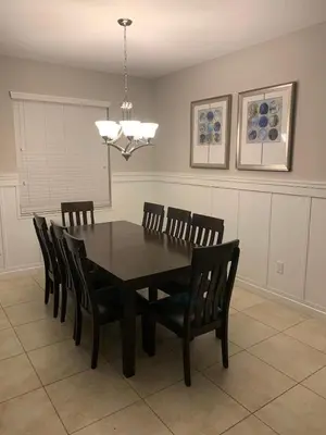 a dining room with a wooden table and chairs at Relaxing Villa very close to Disney and Universal in Kissimmee