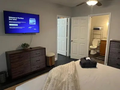 a bedroom with a bed and a tv on the wall at Beautiful Guest Suite with Private Driveway and Entrance in Orlando