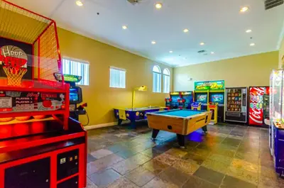a room with several arcade games and a pool table at Holiday Haven at Terra Verde Resort in Kissimmee