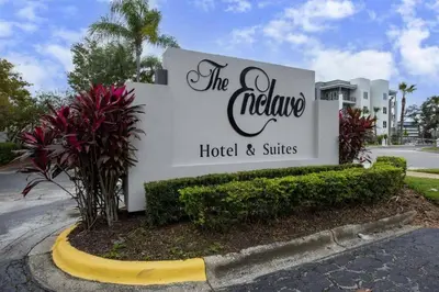 a sign for the palace hotel and suites at NEW Amazing 2 Bedrooms Nex to Universal in Orlando