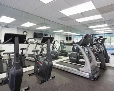 a gym with several treadmills and cardio machines at NEW Amazing 2 Bedrooms Nex to Universal in Orlando