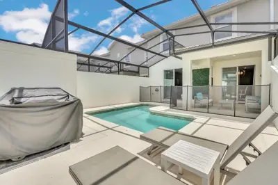 a swimming pool in the backyard of a house at Storey Lake Escape with Pool in Kissimmee