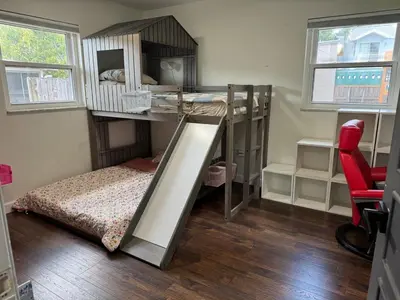 a bedroom with a bunk bed with a ladder at Family Fun 3-bedroom house with gym, games, toys, outdoor hangout and coffee in Orlando