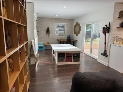 a room with a table in the middle of a room at Family Fun 3-bedroom house with gym, games, toys, outdoor hangout and coffee in Orlando