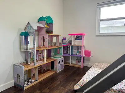 a bedroom with a doll house on shelves at Family Fun 3-bedroom house with gym, games, toys, outdoor hangout and coffee in Orlando
