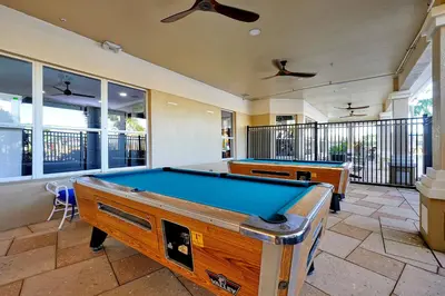 a pool table in a room with windows at Whimsical Mouse Manor in Orlando