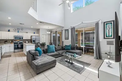 a large living room with a couch and a kitchen at 7 Bed Family Villa for All in Kissimmee